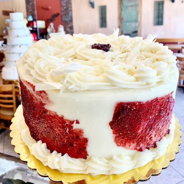 Mama's Bistro Cafe and Bakery's white frosted cake with red fruit filling and white chocolate shavings.